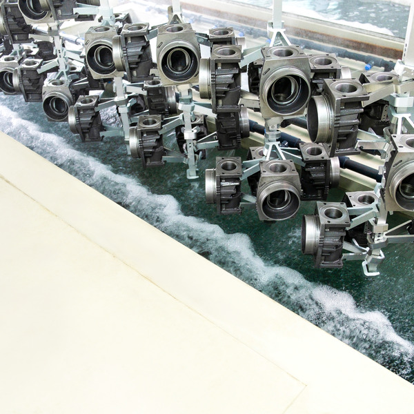 metal castings are immersed in a cleaning bath for surface treatment metal castings are immersed in a cleaning bath for surface treatment